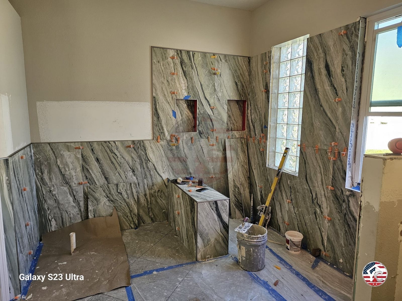 Large-format stone-look tile installation in progress